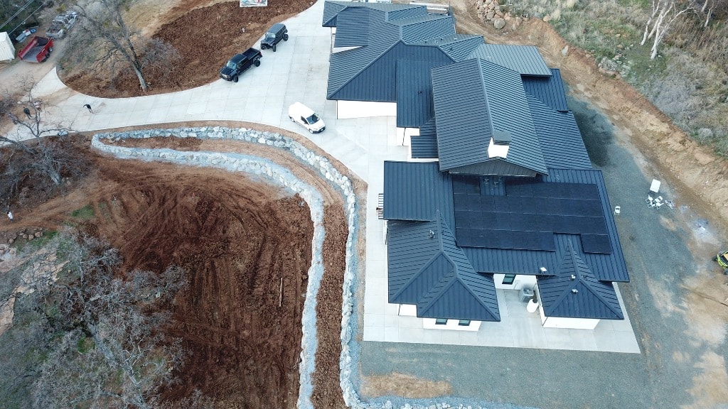 Aerial view of large estate with grading and stone retaining walls