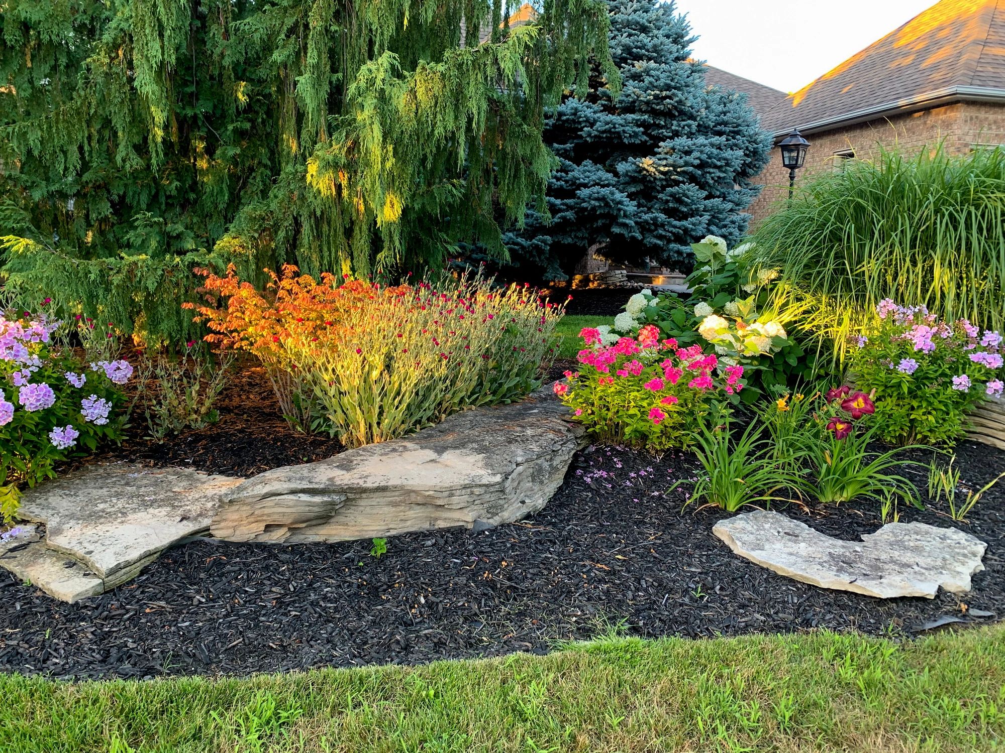 Garden pathway lined with hydrangeas and brick