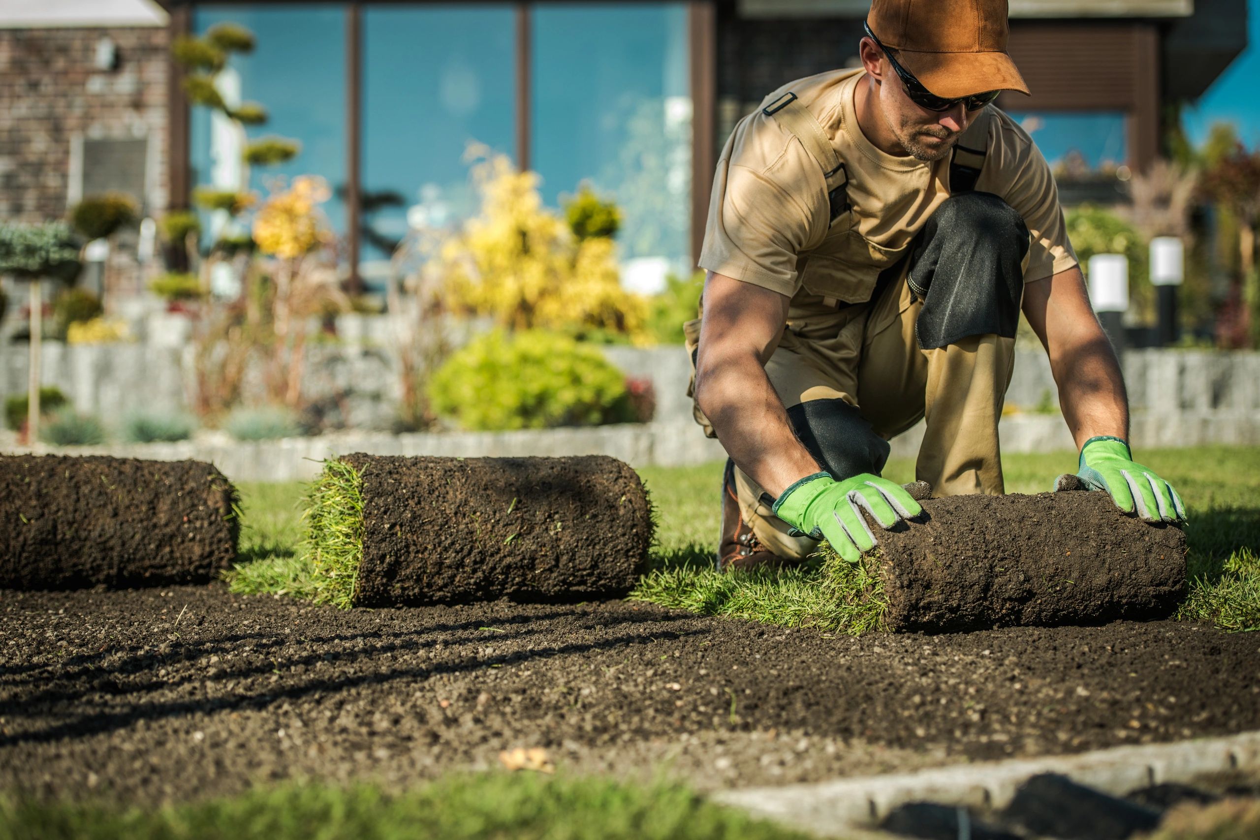 TZ Landscape worker laying sod in a residential yard in Sacramento